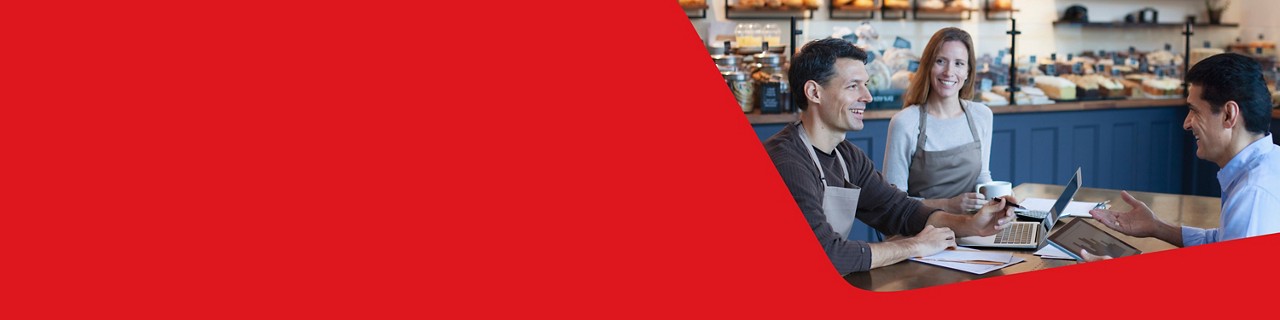 Photo of two restaurant owners discussing their short-term financing needs with a National Bank advisor 