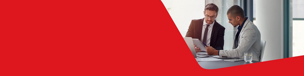 Photo of two businessowners in an office discussing ways to optimize their business management with National Bank 