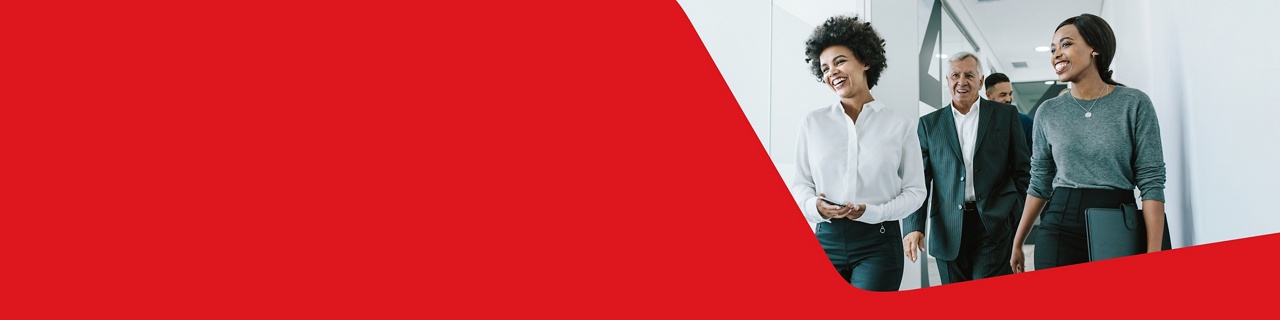 Photo of employees of a commercial business walking in an office, happy with National Bank’s services