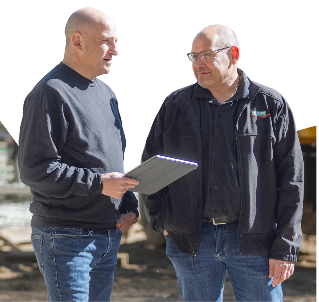 Photo of a dealer and a National Bank expert discussing their equipment financing needs 