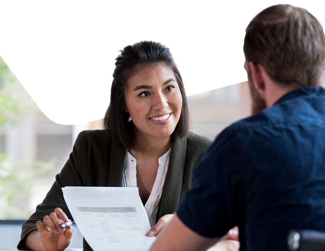 Photo of an advisor showing the National Bank loan insurance to their client 