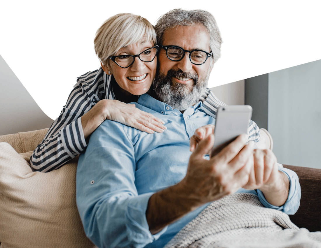 Photo of two retirees in Florida checking on their phone their Natbank’s bank account