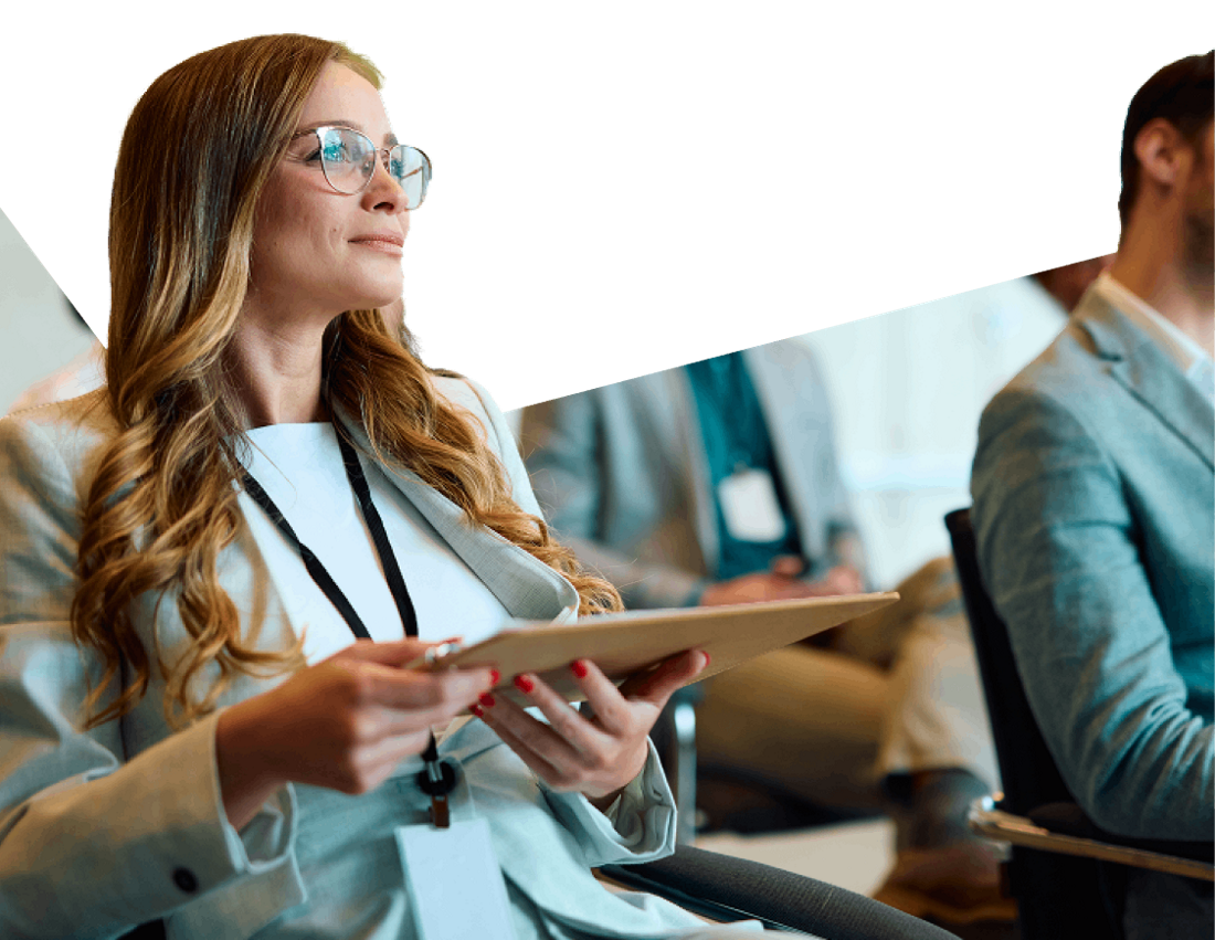 Photo of a professional taking notes on her tablet at a National Bank Capital Markets conference