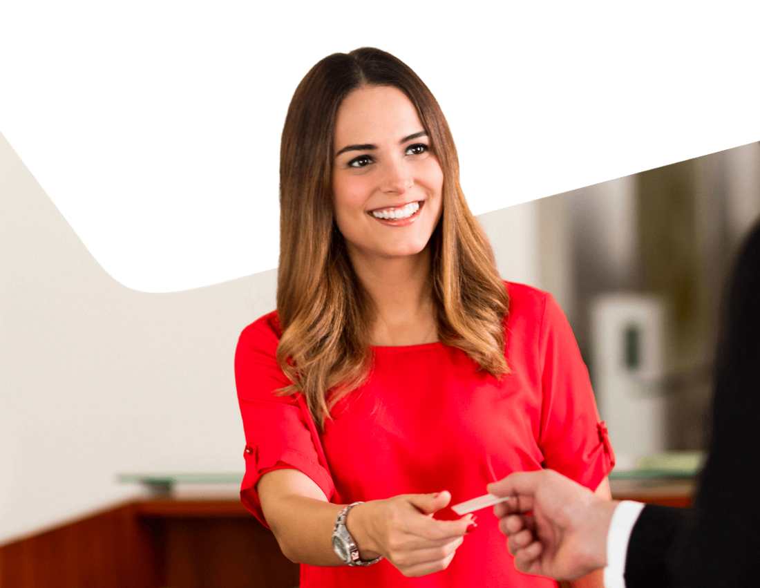 Photo of an advisor giving a client a business card at a branch in Florida