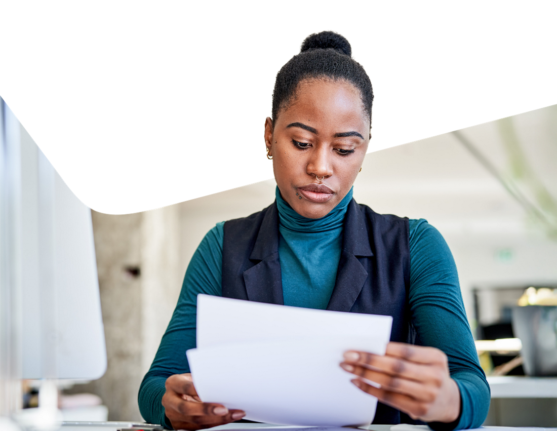 Photo of a woman consulting the documentation related to her Mastercard credit cards no longer offered to business clients