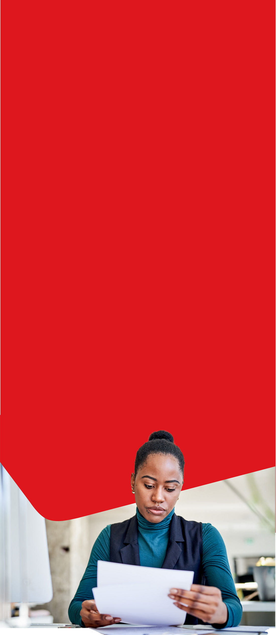 Photo of a woman consulting the documentation related to her Mastercard credit cards no longer offered to business clients