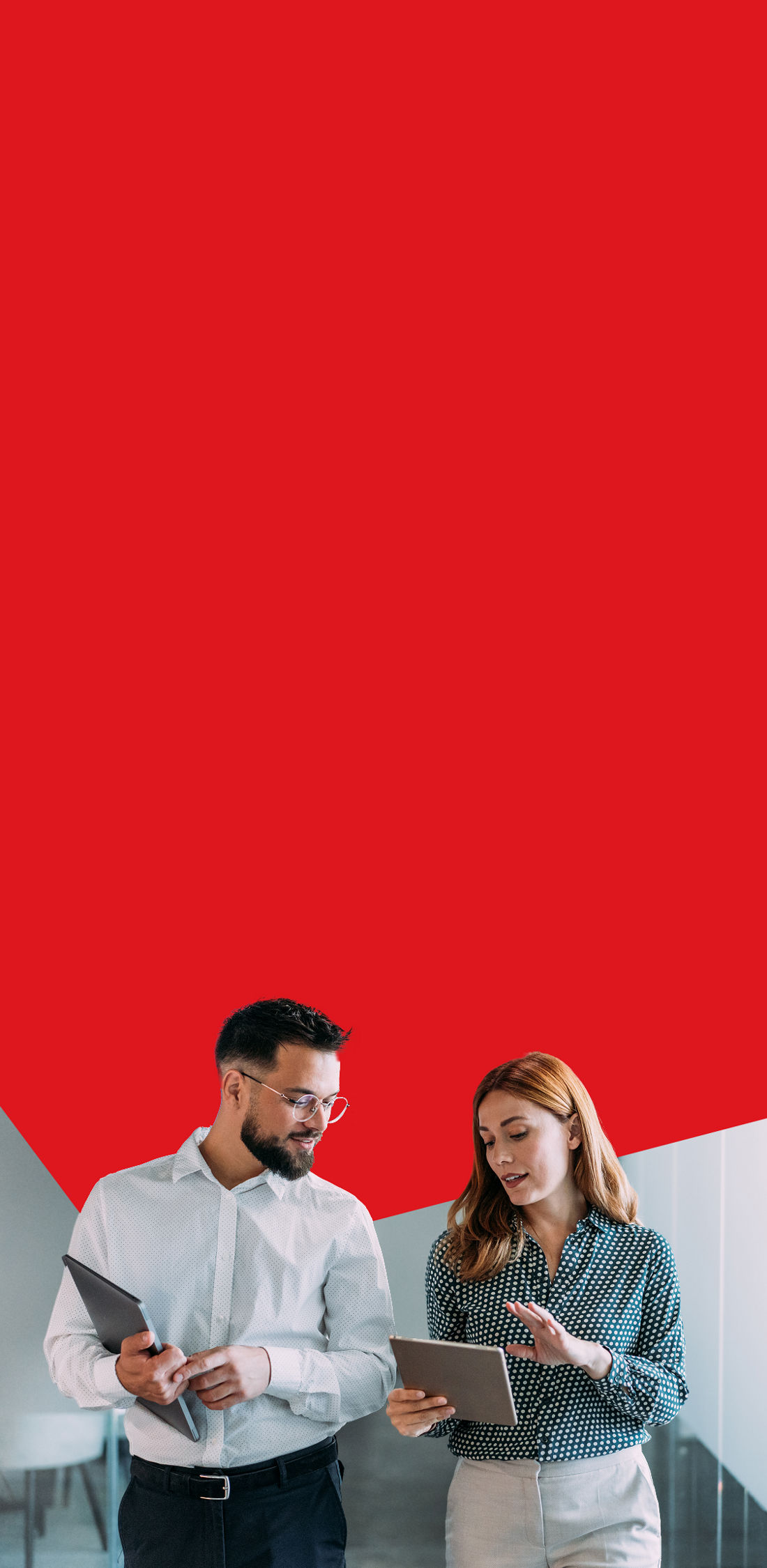 Photo of two entrepreneurs in an office looking at their tablets and discussing their USD account 