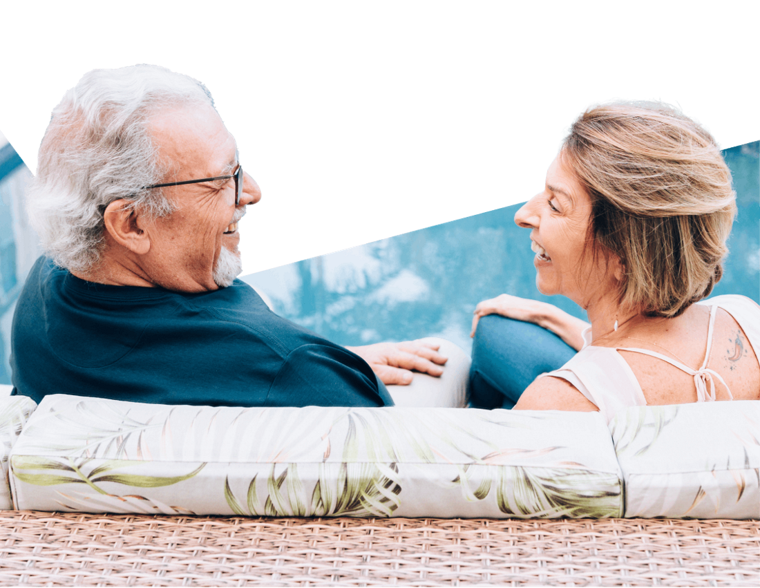 Photo of a retired couple talking by a pool in Florida