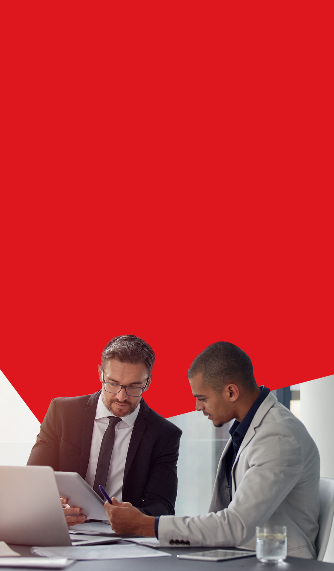 Photo of two businessowners in an office discussing ways to optimize their business management with National Bank 