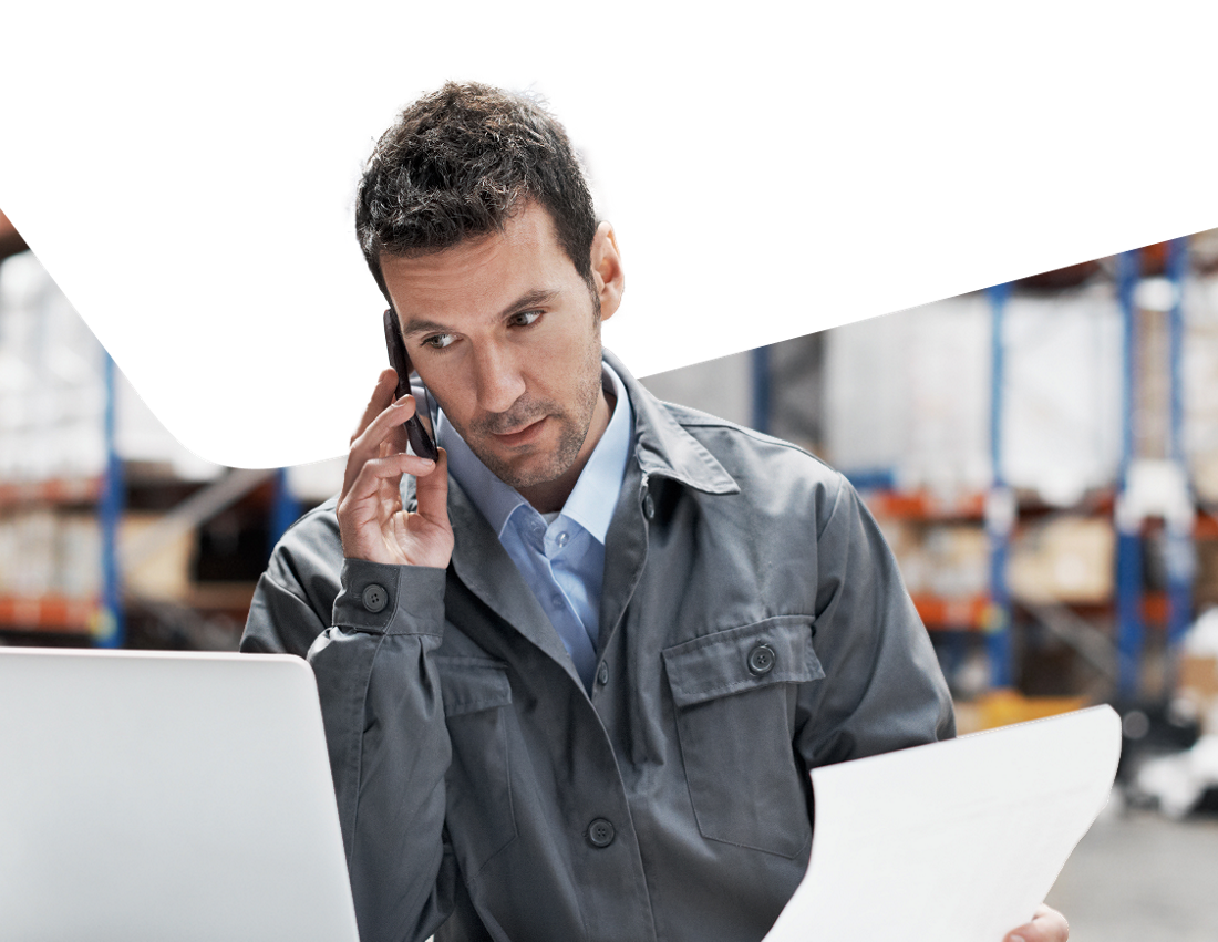 Photo of a man speaking on the phone managing his international payments 
