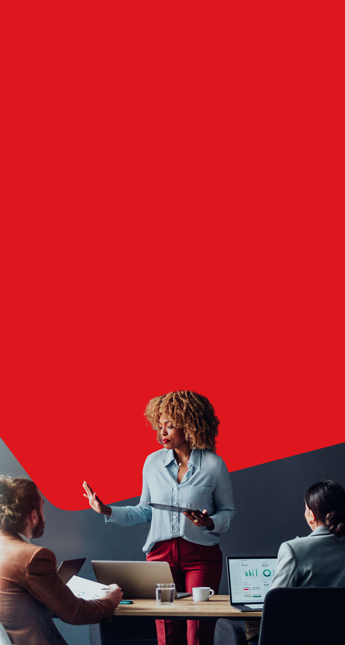 Photo of a SME business owner using National Bank services doing a presentation for their colleagues at an office