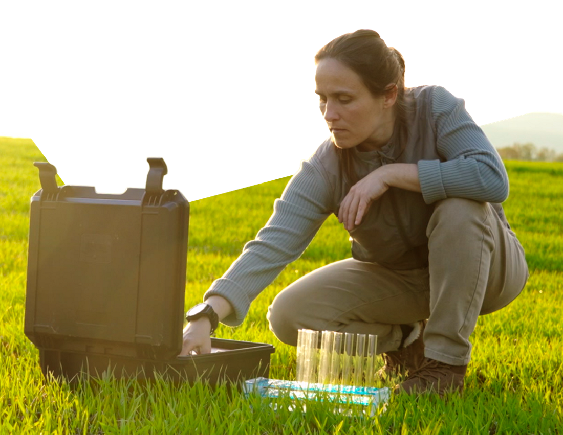 Photo of a sustainability expert carrying out tests on a field