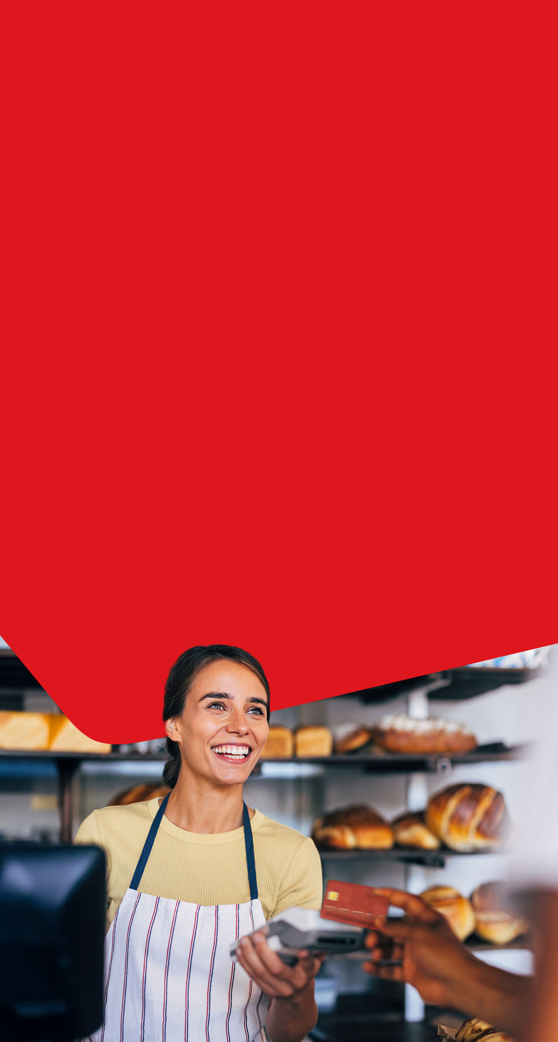 Photo of a coffee shop owner and a client completing a transaction with a Clover payment terminal 