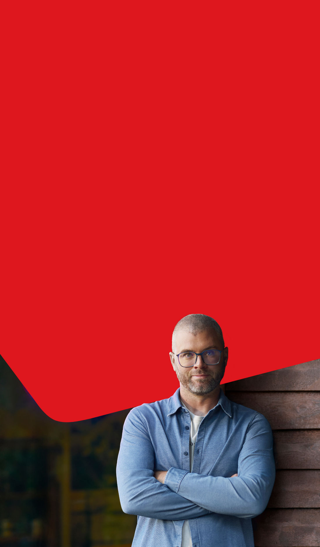 Photo of a business owner in front of their business with an open sign representing National Bank’s business transfer services 