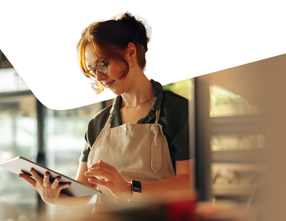Photo of a business owner making an Interac e-Transfer on their tablet 