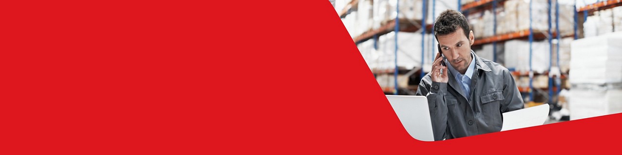 Photo of a man speaking on the phone managing his international payments 