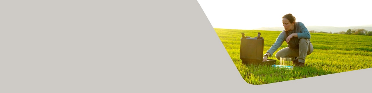 Photo of a sustainability expert carrying out tests on a field