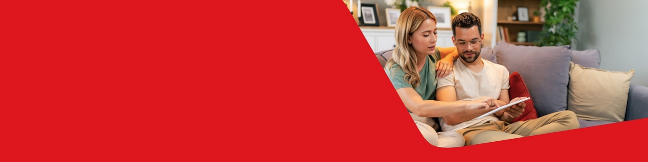 Photo of a couple learning the basics about mortgages by reading on their tablet