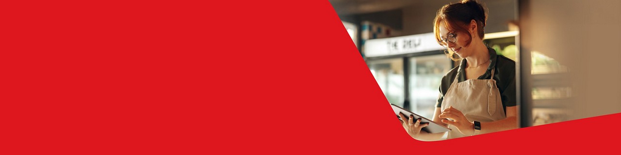 Photo of a business owner making an Interac e-Transfer on their tablet 