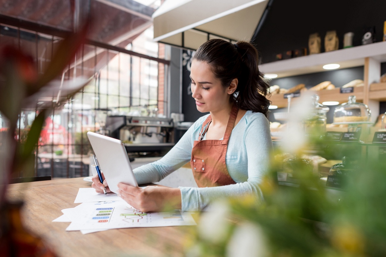 Photo of a business owner working on their laptop representing business accounting