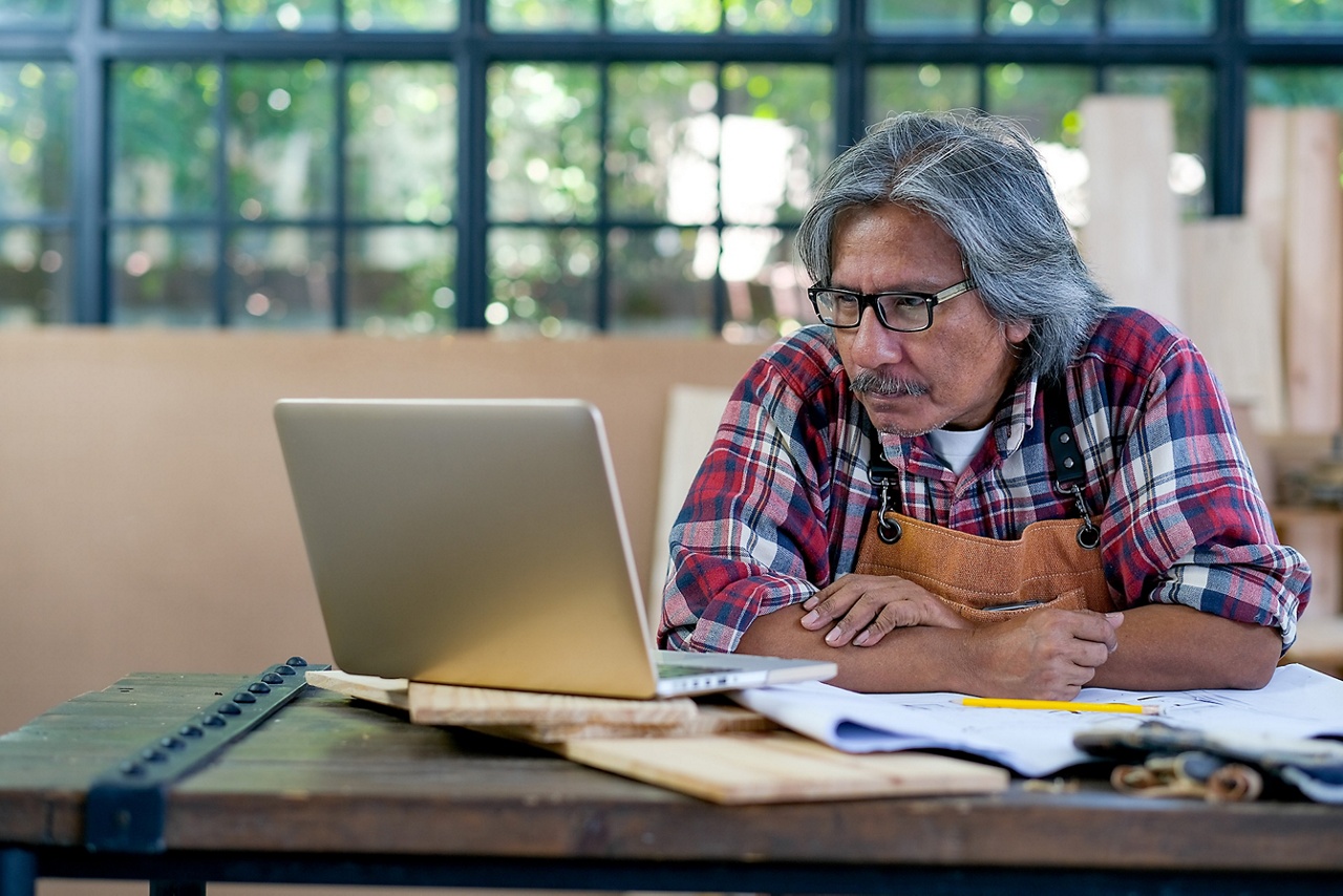 Photo of an equipment dealer business owner reviewing his financing options