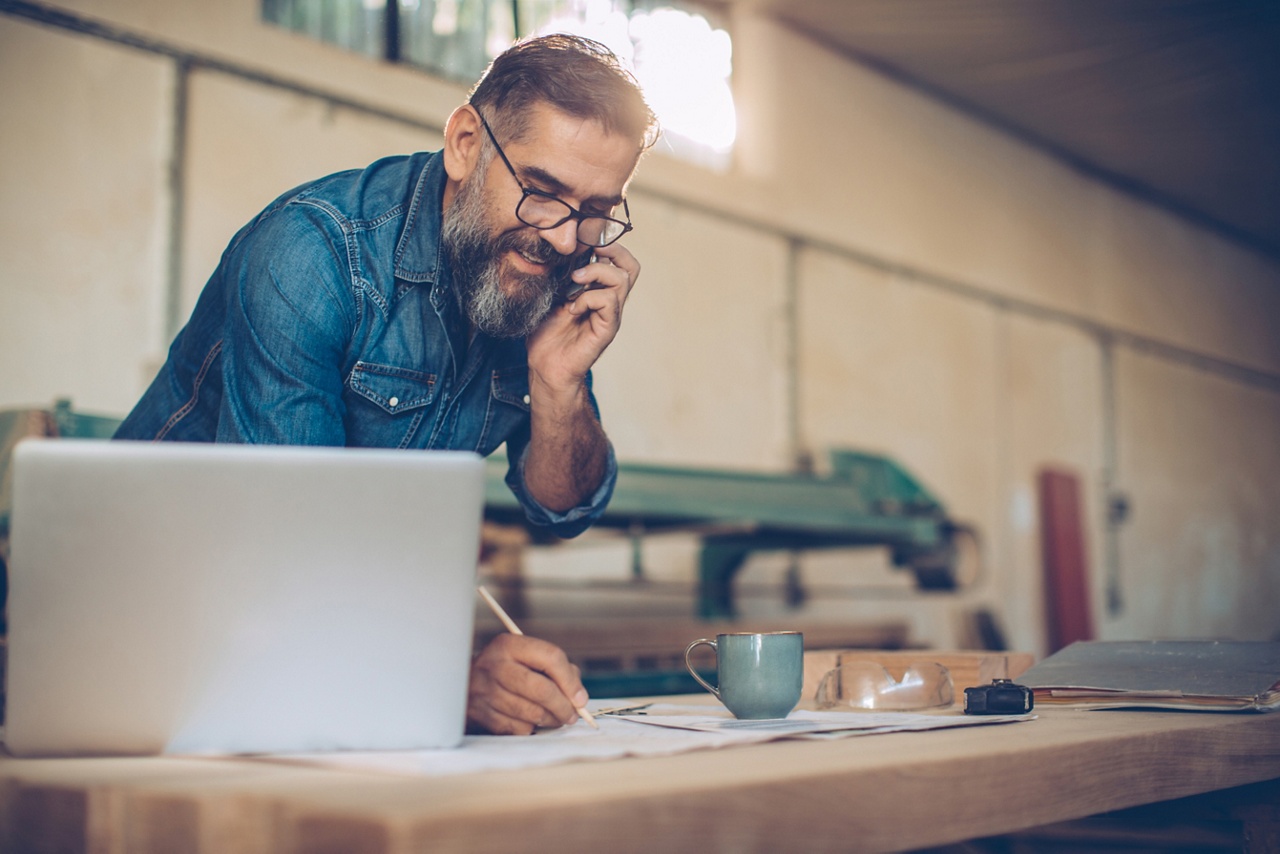 Photo of a business owner on the phone representing business development 