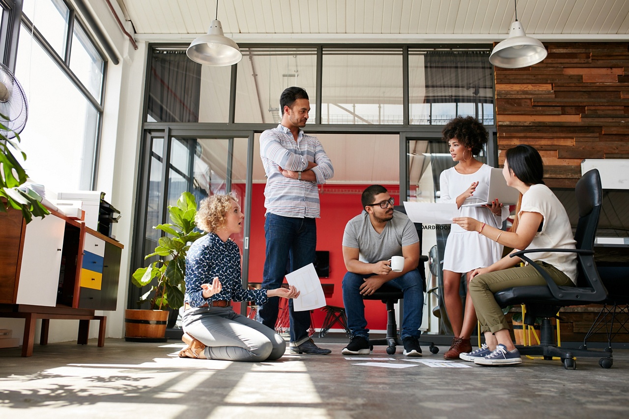 Photo of a group of people working in an office discussing expanding their business internationally 
