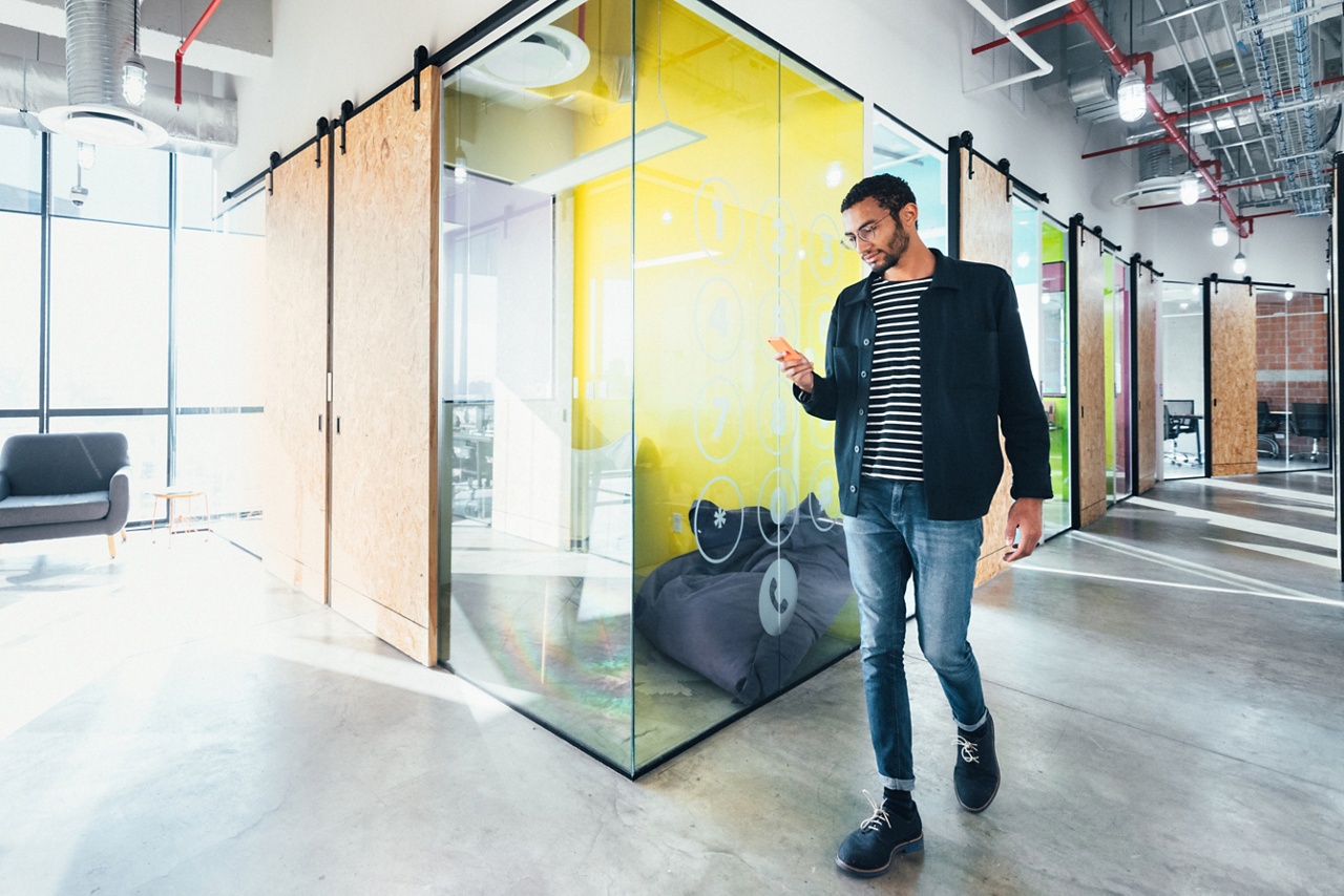 Photo of a person walking through a modern office for an article on business incubators