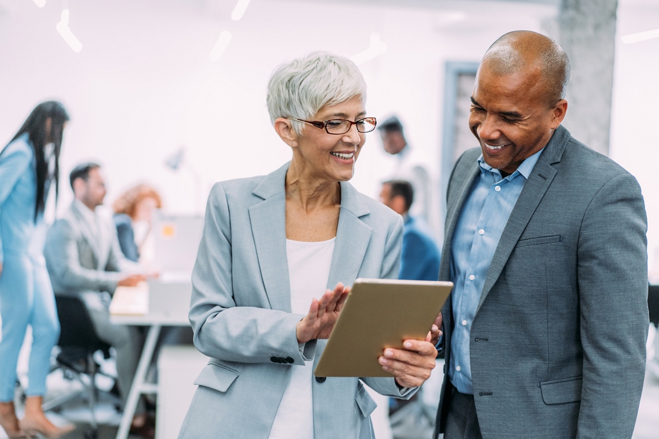 Photo of two entrepreneurs speaking in an office for an article about creating a strong business succession plan 