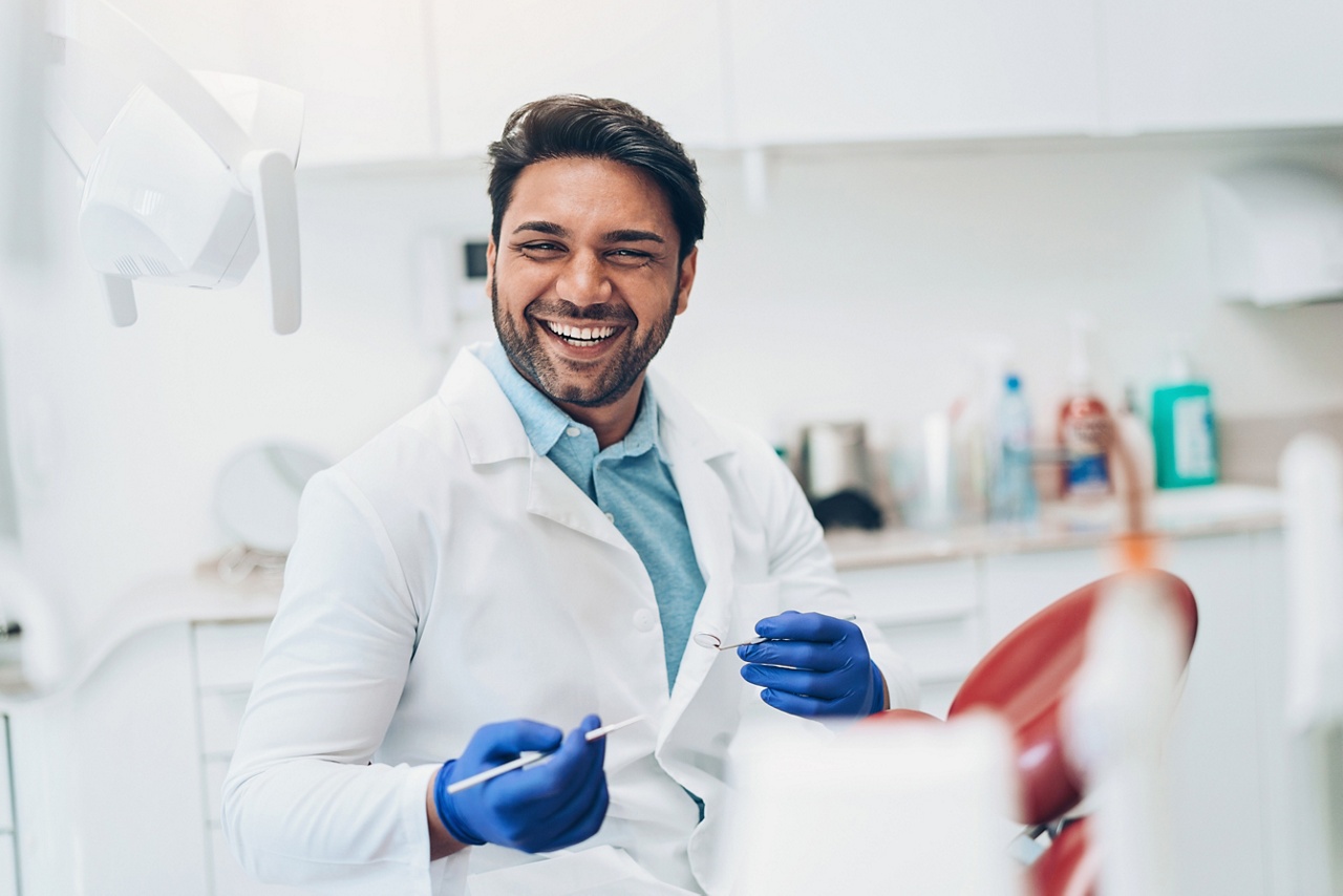 Photo of a dentist for an article about the benefits and drawbacks of holding companies