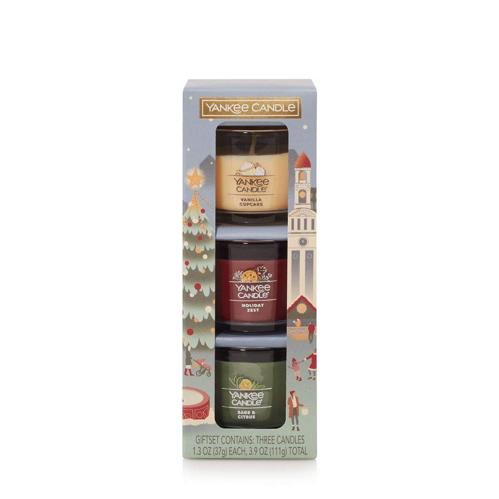 Gift set with three scented candles in a holiday-themed box, including vanilla, balsam, and berry scents.