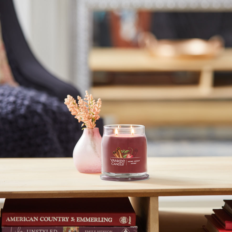 home sweet home signature medium jar candle on coffee table