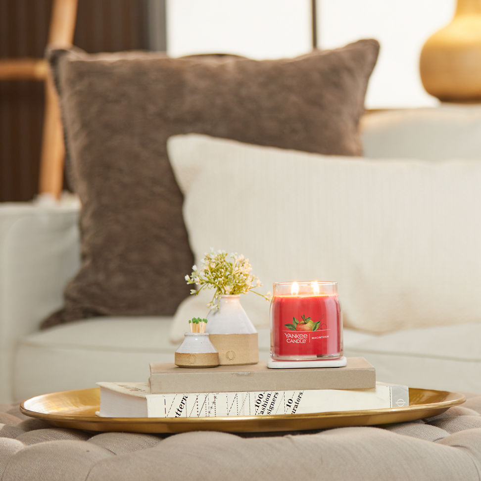 macintosh signature medium jar candle on table