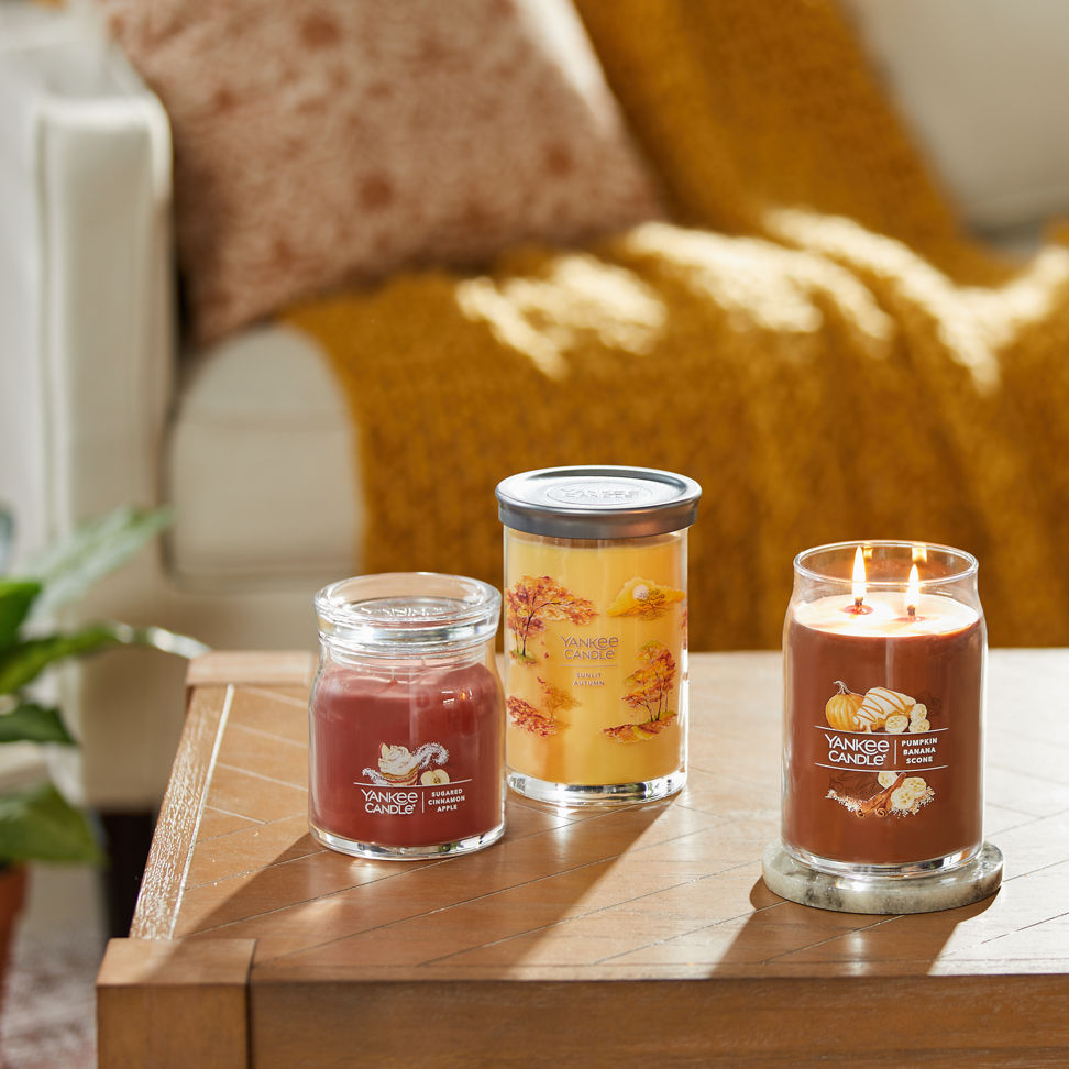 sugared cinnamon apple signature medium jar candle, sunlit autumn signature large tumbler candle, and pumpkin banana scone signature large jar candle