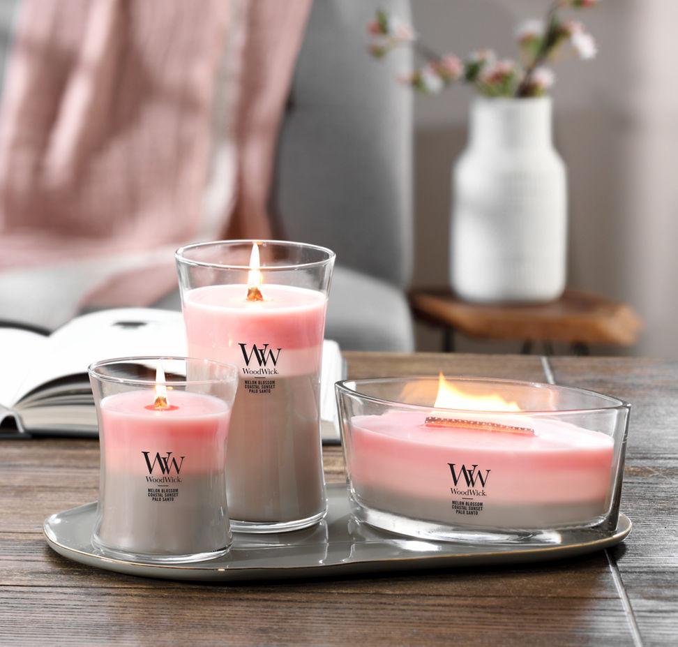 melon blossom and coastal sunset and palo santo trilogy large and medium jar candles and ellipse candle on tray