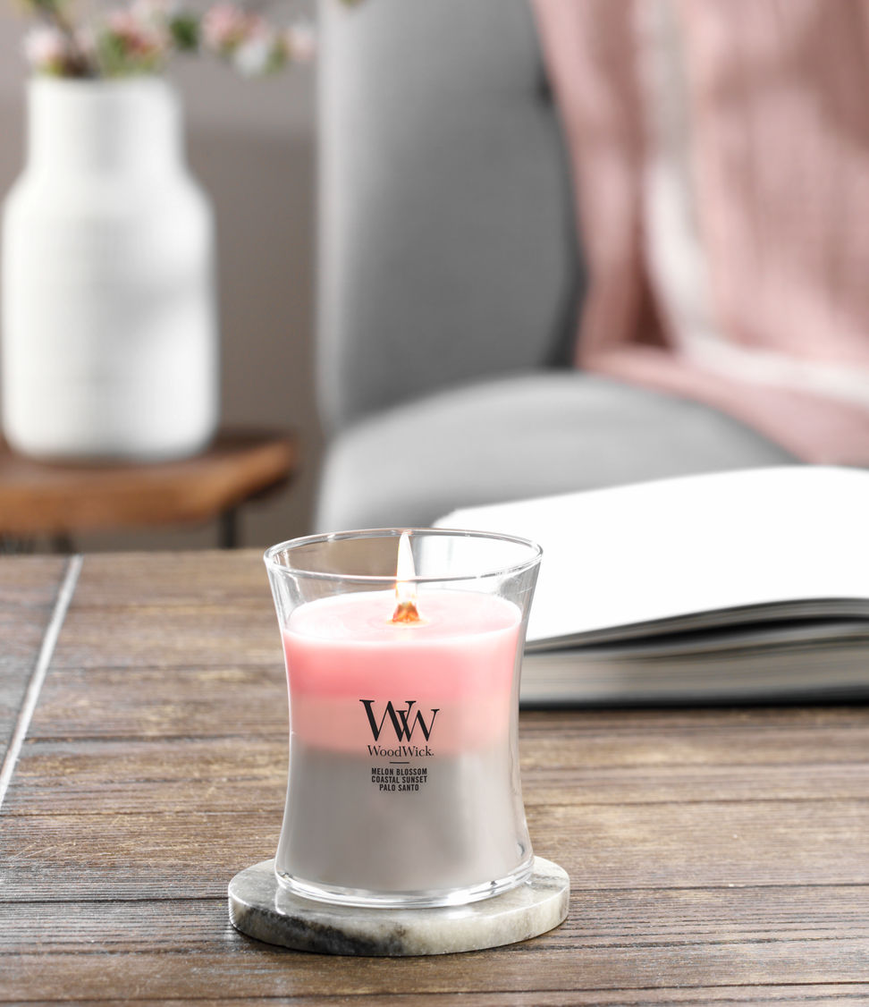 melon blossom and coastal sunset and palo santo trilogy medium jar candle on lid