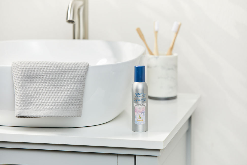 snow globe wonderland concentrated room spray next to a white sink