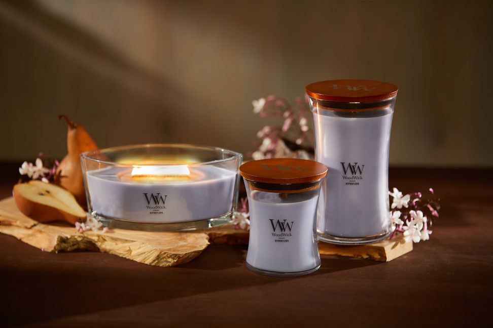 WoodWick Enchanted Destinations Collection Hypnoflora Ellipse Candle, Hypnoflora Medium Hourglass Candle, and a Hynoflora Large Hourglass Candle on a table