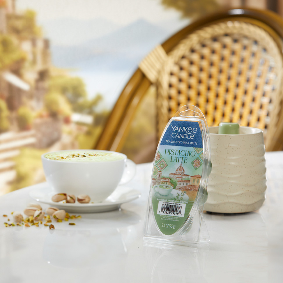 Sandstone Wax Warmer and Hello, Italy! Collection Pistachio Latte Wax Melts (6-Pack) on a table with pistachios and a latte