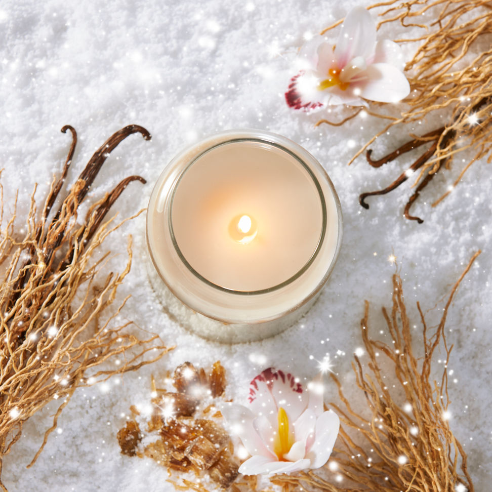 Apres Ski Collection Vanilla Flurries Original Large Jar Candle in snow surrounded by a flower and vanilla