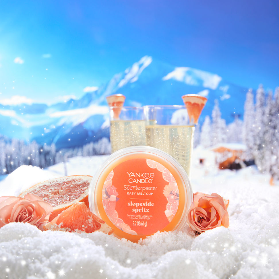 slopeside spritz easy meltcup on a snowy mountainside with sliced grapefruit roses and glasses of sparkling wine