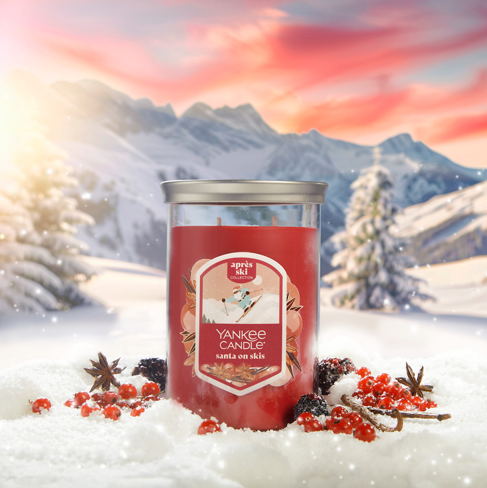 Apres Ski Collection Santa on Skis Signature Large Tumbler Candle in snow surrounded by berries, spices, and mountains