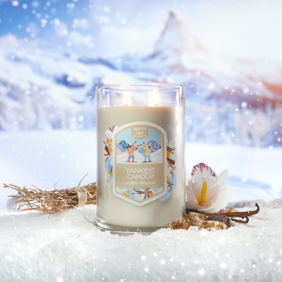 Apres Ski Collection Vanilla Flurries Signature Large Tumbler Candle in snow surrounded by mountains, vanilla, and a flower