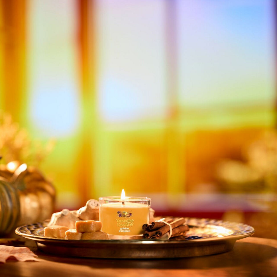 Scented candle on a tray with cookies and cinnamon sticks, cozy home decor and relaxation atmosphere