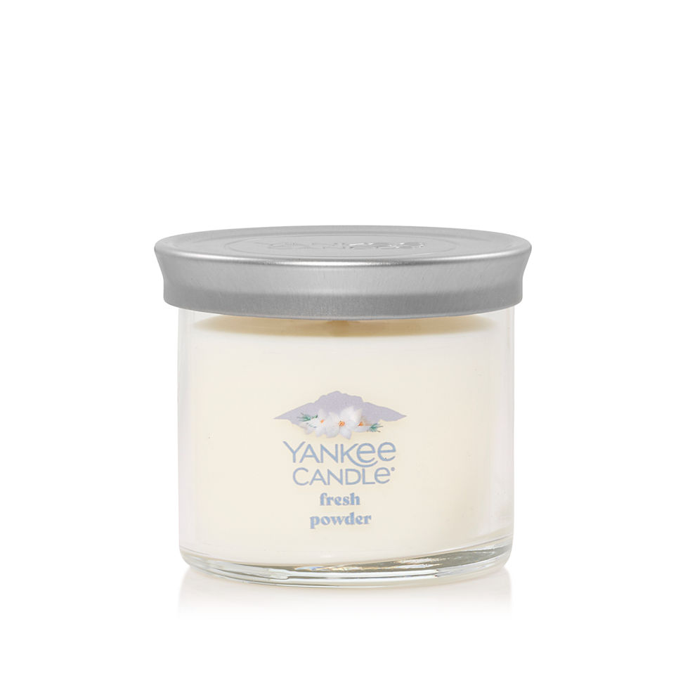 small tumbler candle in fresh powder