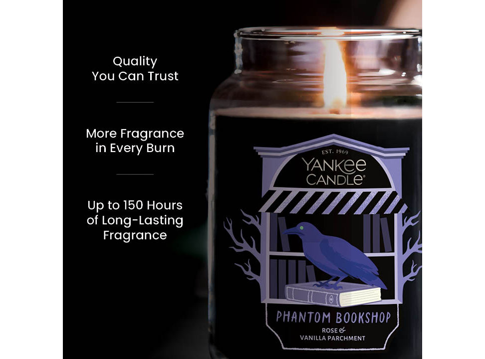 Large jar candle with burning wick, purple label, and text promoting quality, long-lasting, strong fragrance