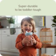 Toddler with Nuk sippy cup that is super durable to be toddler tough image number 1