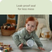 Baby holding Nuk sippy cup with leak proof seal for less mess image number 4