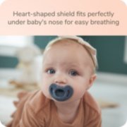 Baby with Nuk pacifier with heart shaped shield that fits perfectly under baby's nose for easy breathing image number 4