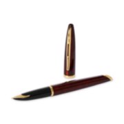 A Carene fountain pen with gold trim laid next to a pen cap stood upright. image number 3